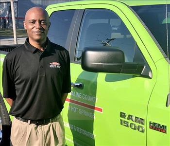 Kevin Hunter - SERVPRO of Saline County and SERVPRO of Hot Springs General Manager stands next to a green work truck.