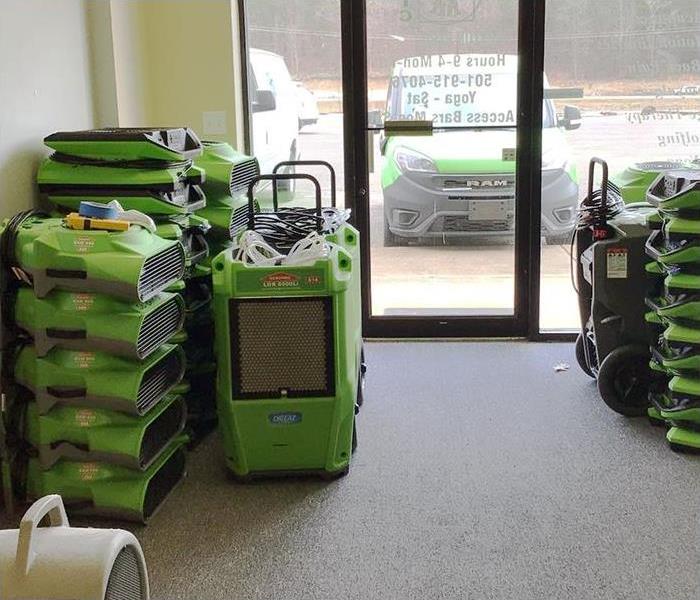 Stacks of SERVPRO equipment at the entrance of a business who suffered a loss