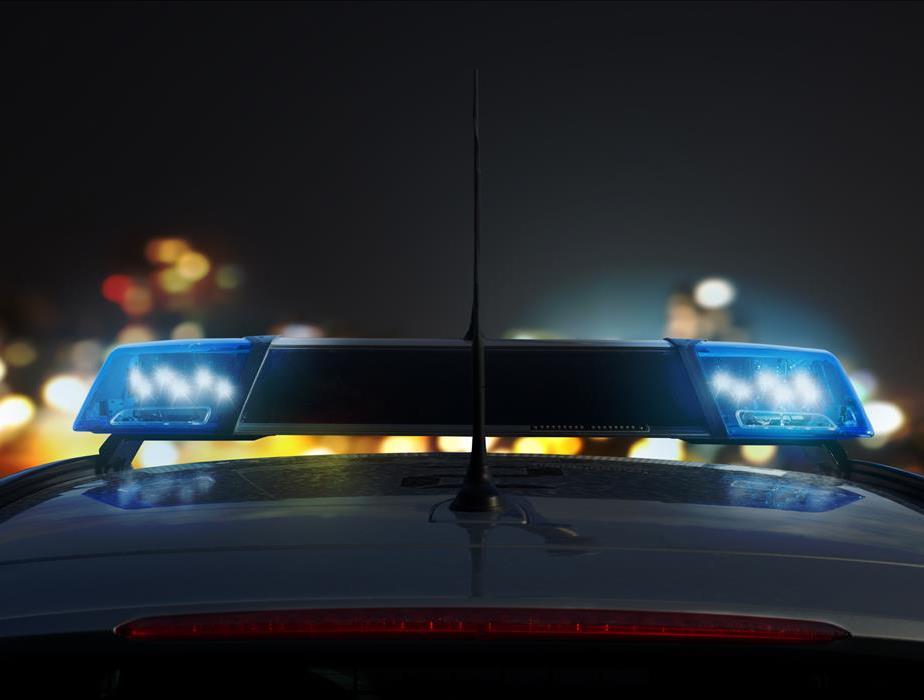 Closeup of engaged blue lights on top of a police car