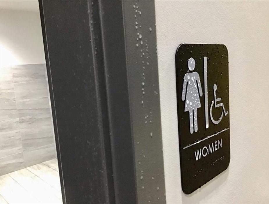 Water droplets on women’s bathroom sign